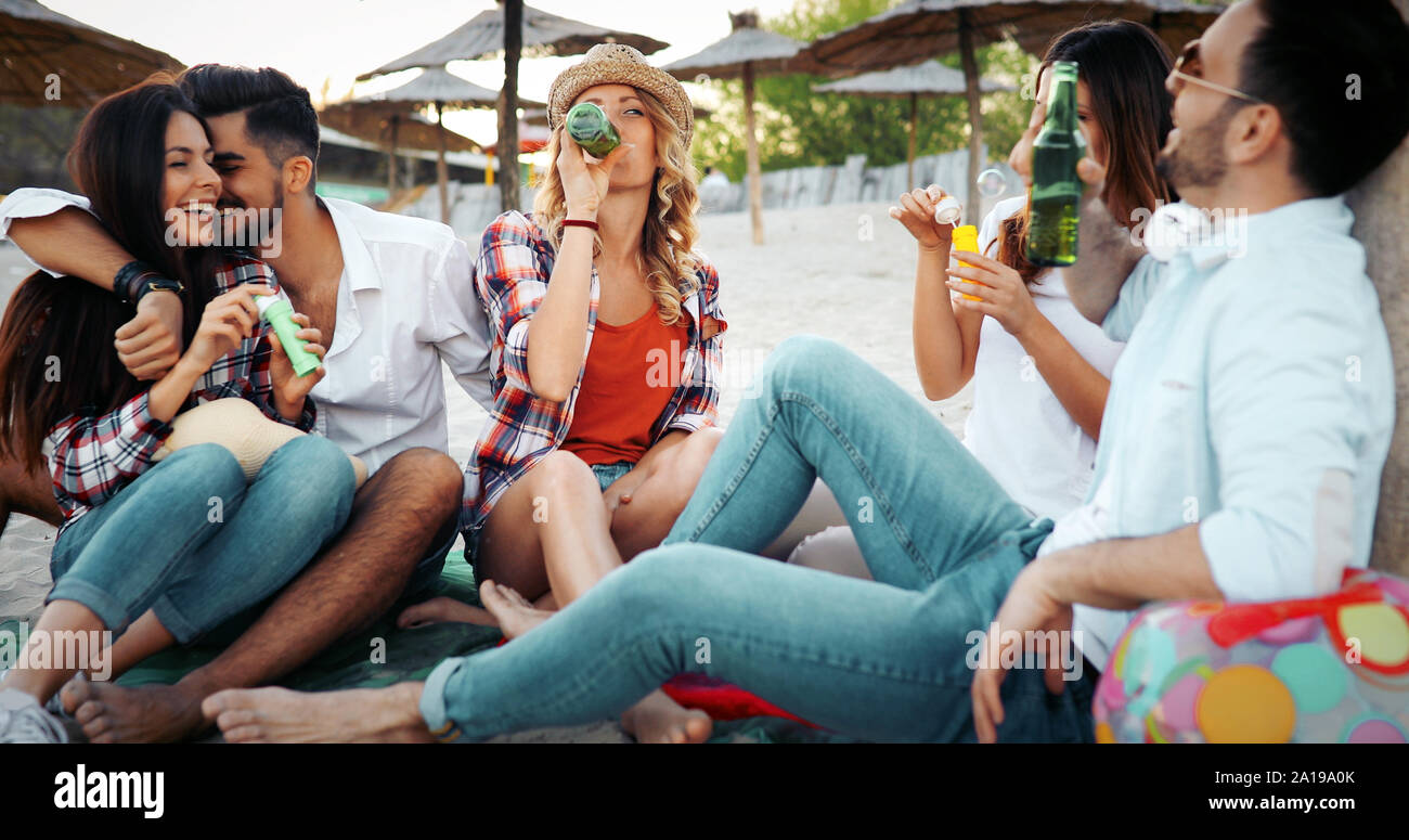 Beach party with friends. Cheerful young people spending nice time together on the beach Stock Photo