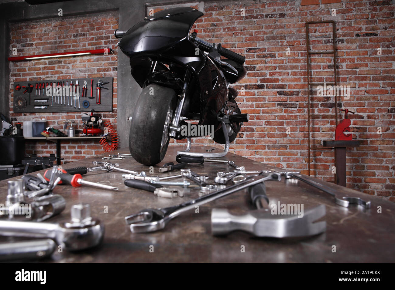 Do It Yourself Concept Motorcycle In The Garage With Red Brick