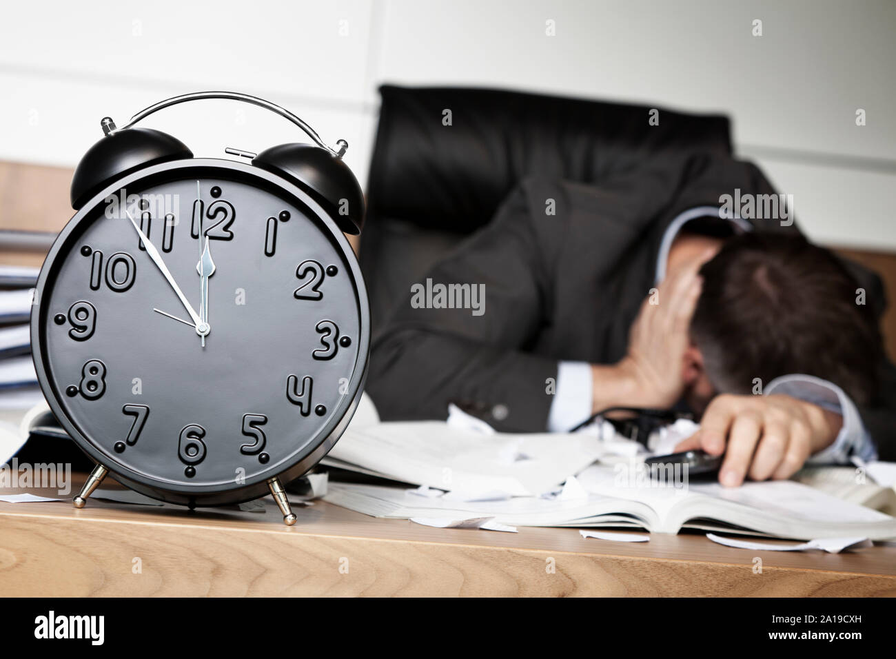 Depressed businessman down after receiving bad message. Stock Photo