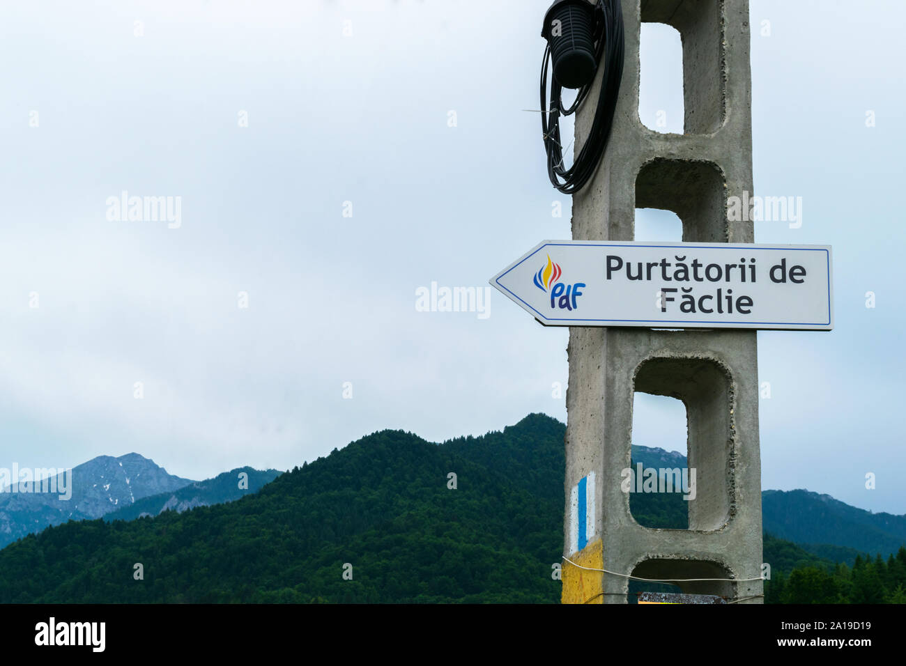 Rasnov, Brasov, Romania - June 16, 2019: Road sign poiting to 'Purtatorii de Faclie' (Torchbearers). 'Purtatorii de Faclie' is a bible school member o Stock Photo