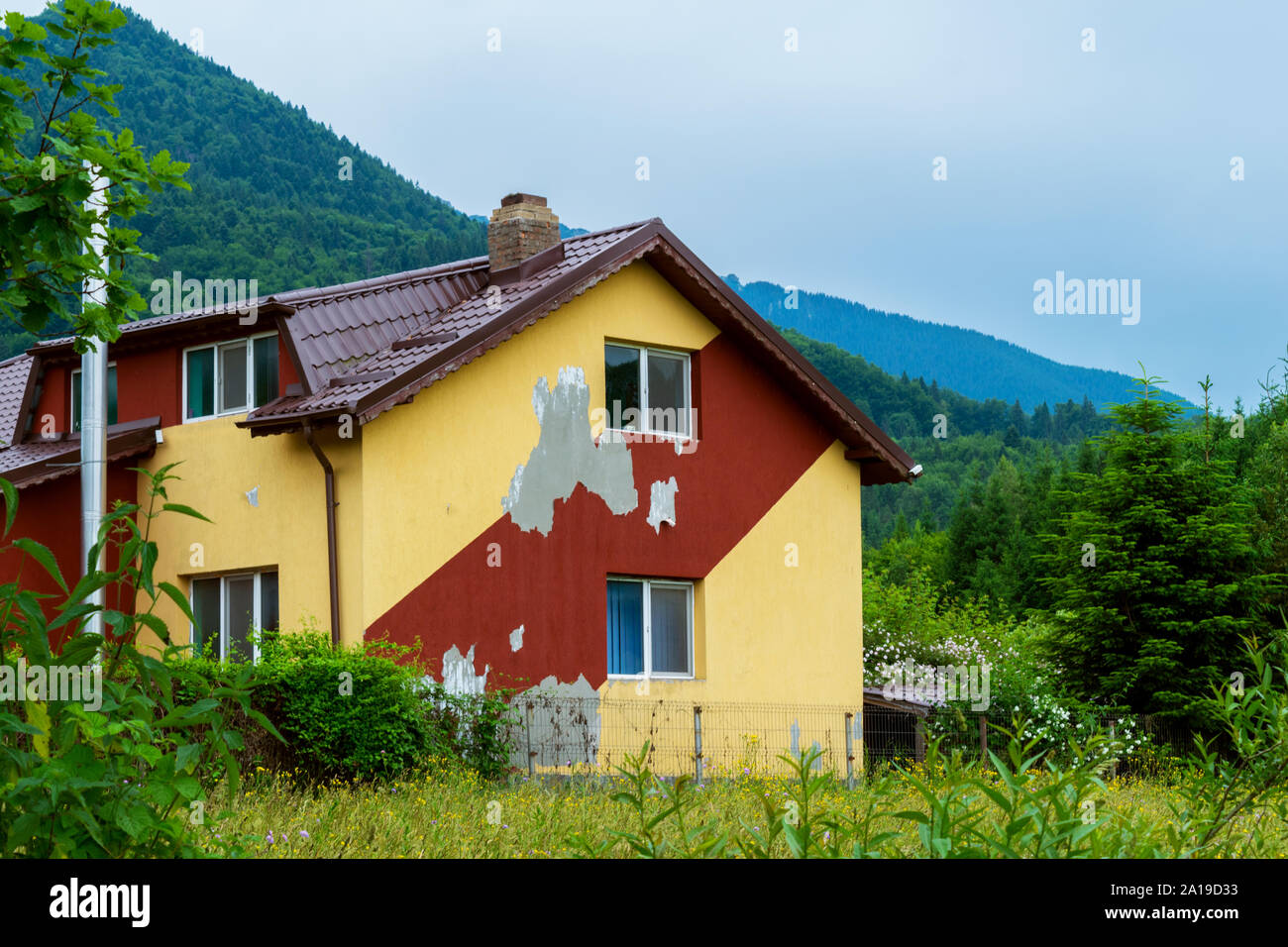 deteriorated modern house facade paint needs repairing for cosmetic purposes Stock Photo