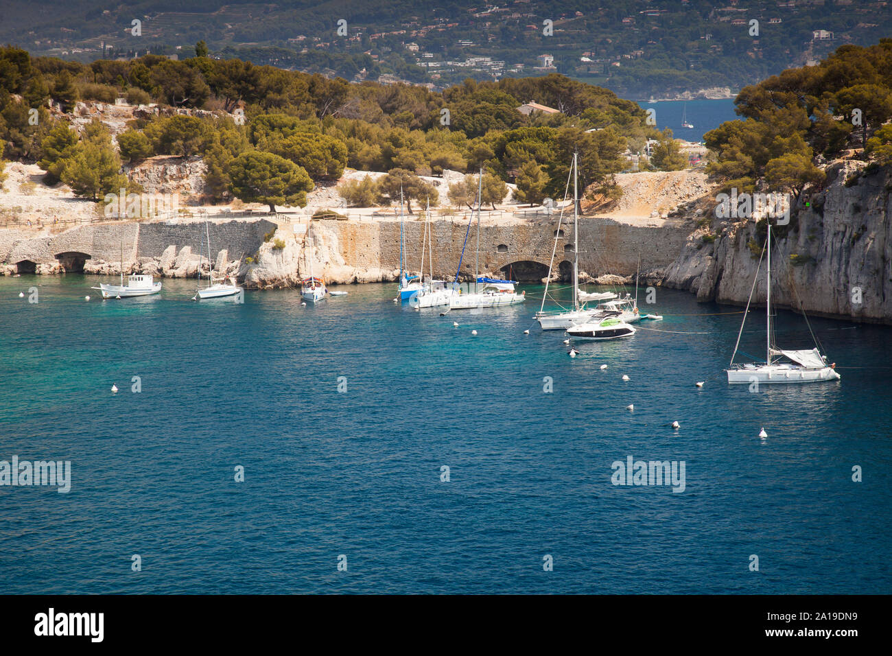 Sailboats moored in a bay of the rocky coast, Calanque de Port Pin, Provence, France, Europe Stock Photo