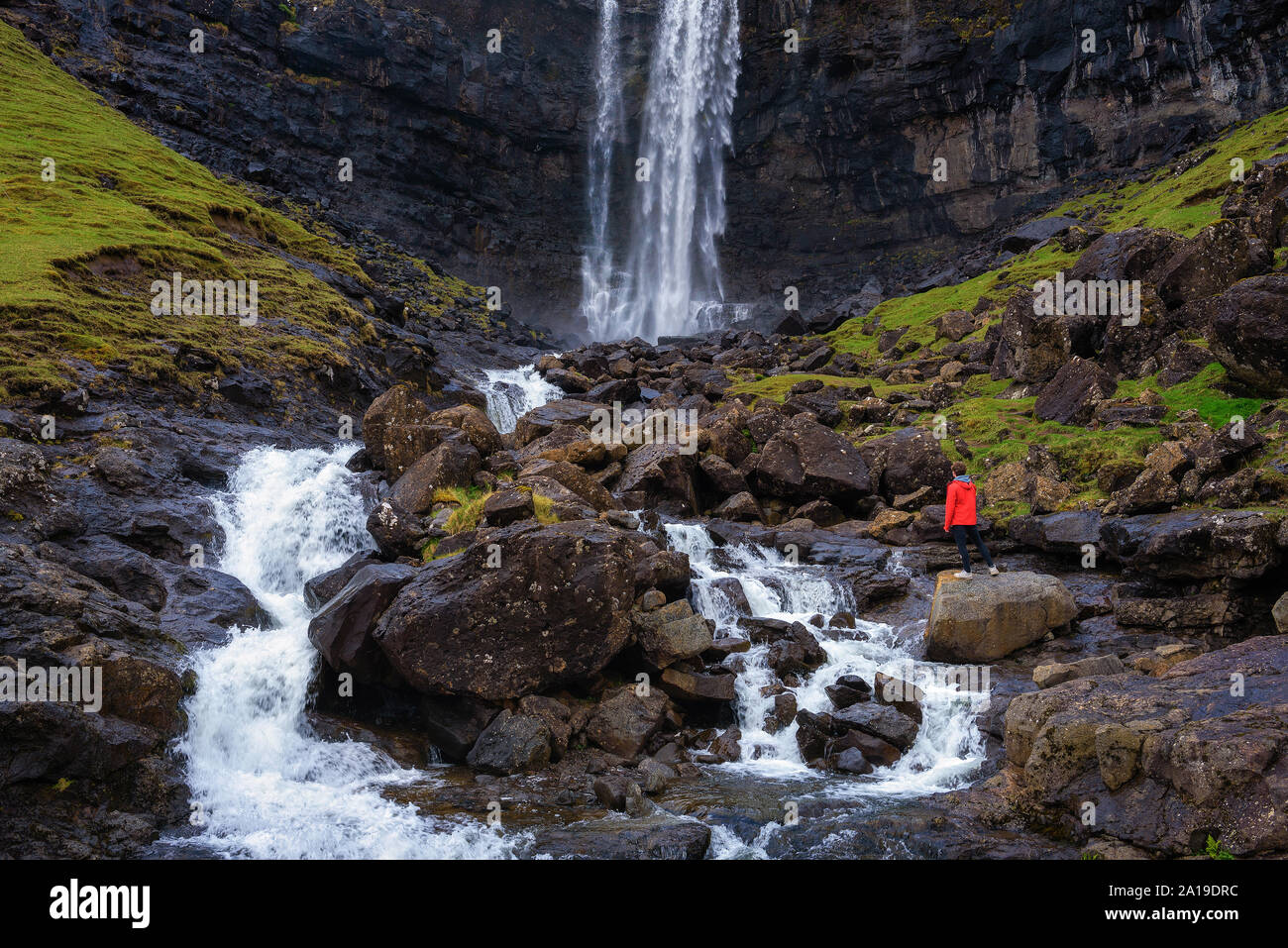 Tourist at the Fossa Waterfall on island Bordoy in the Faroe Islands Stock Photo