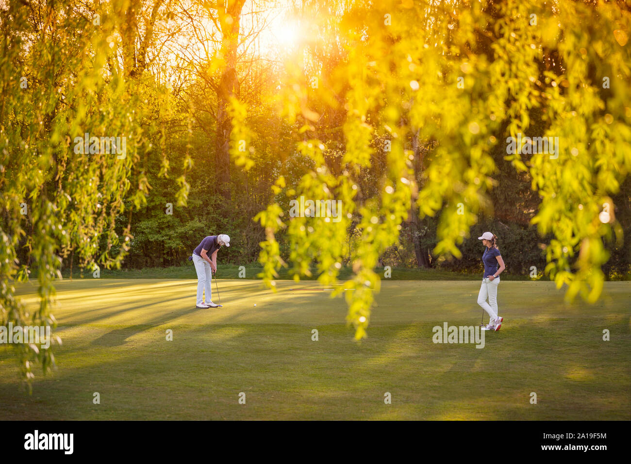 Golf player couple on green. Stock Photo