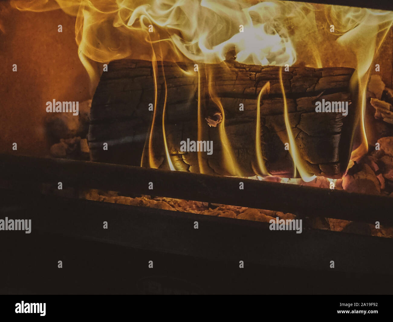 Log burning inside fireplace at Christmas Stock Photo