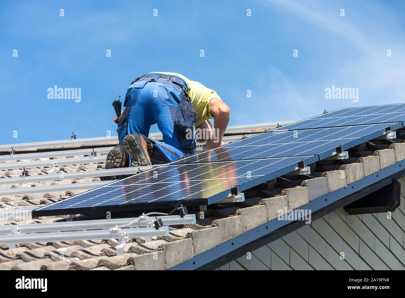 Installing solar photovoltaic panel system. Solar panel technician ...