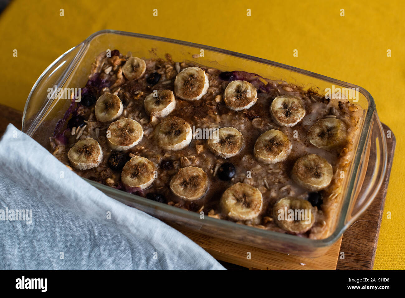 Baked oatmeal with bananas, blueberries, and walnuts. served in a glass bowl Stock Photo