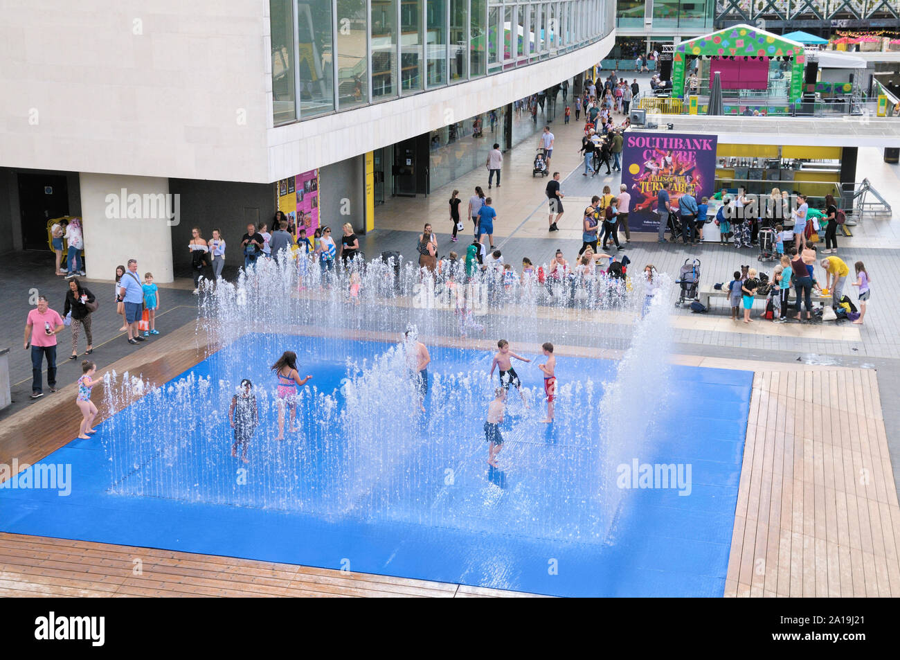 Children having fun playing in the water jet fountains in the Appearing Rooms installation by Danish artist Jeppe Hein, Southbank Centre, London, UK Stock Photo