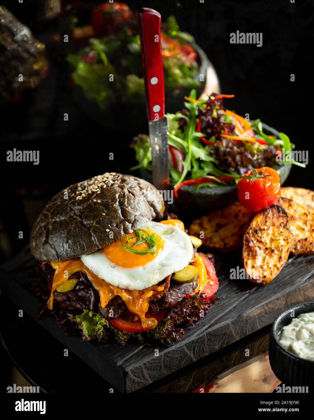 Cheeseburger with bacon and egg in brown bread Stock Photo