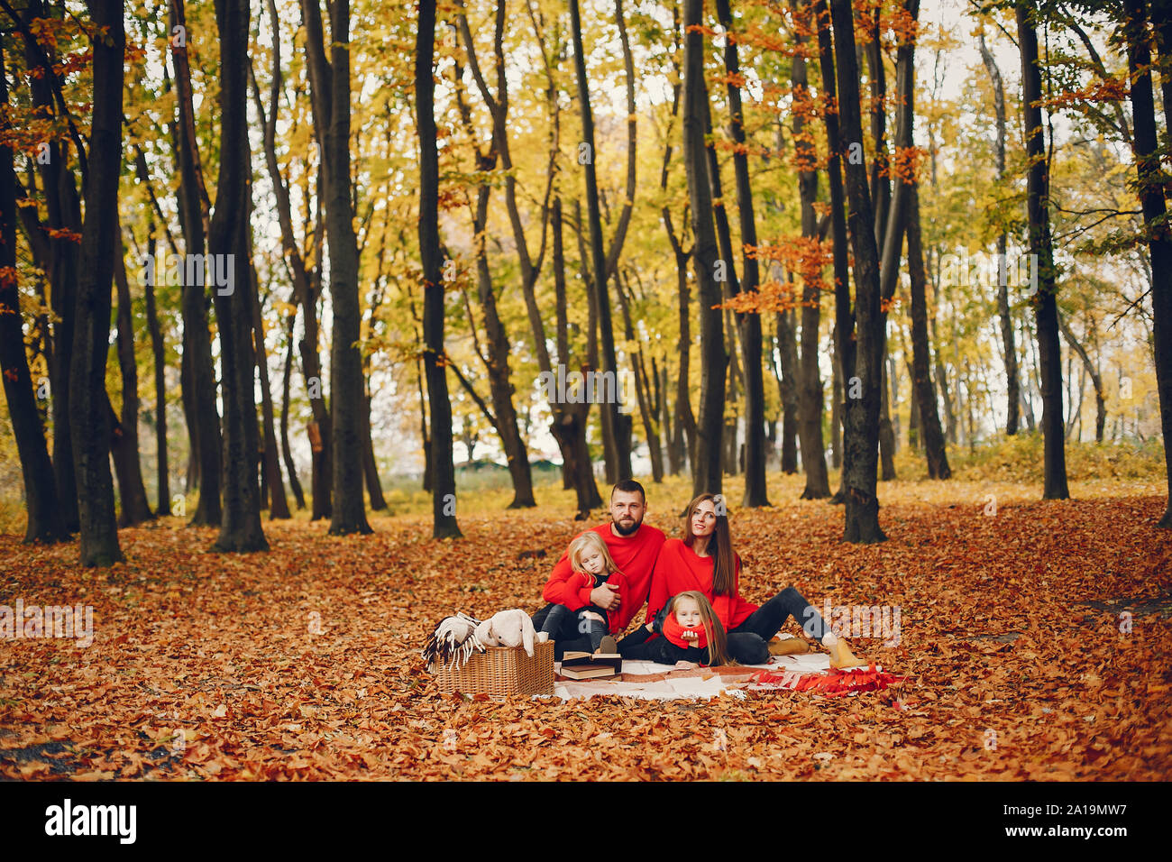 Family with cute kids in a autumn park Stock Photo - Alamy