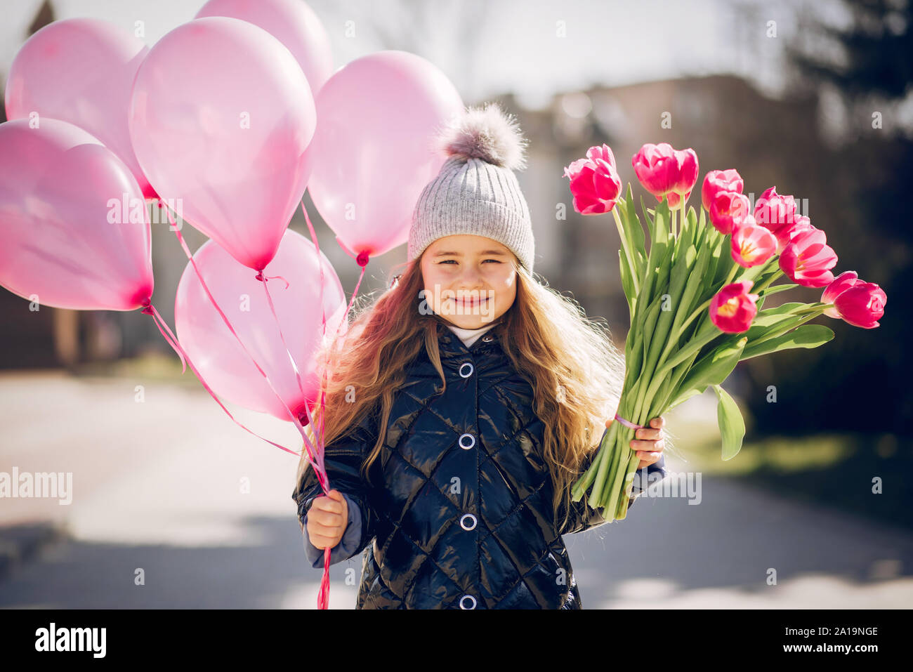 Little girl in a park playing on a grass Stock Photo - Alamy