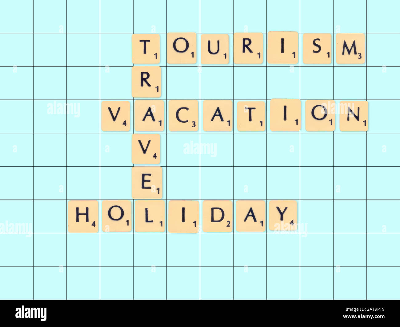 Digitally created Scrabble tiles on a board spelling out Travel tourism and holiday concepts Stock Photo