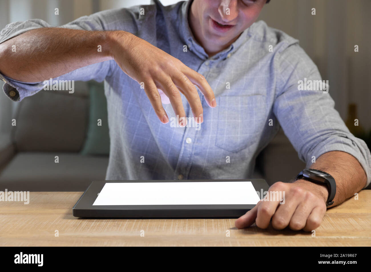 Young man using tablet computer on a table Stock Photo
