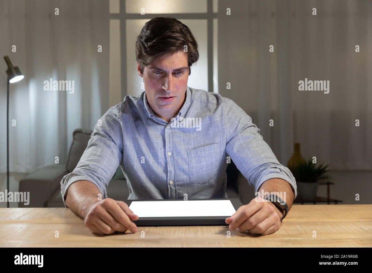 Young man using tablet computer on a table Stock Photo