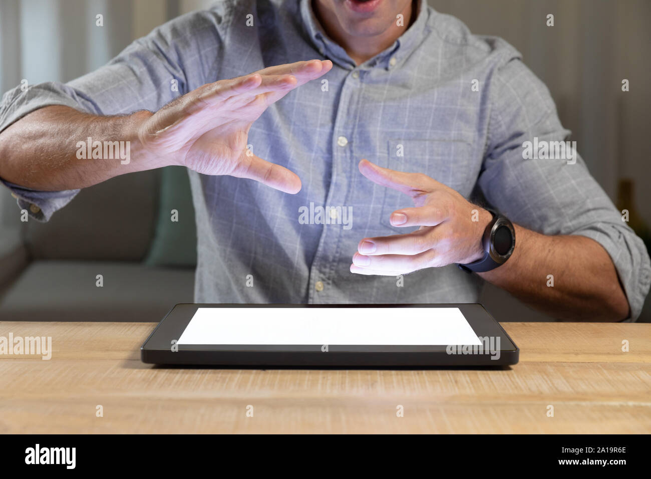 Young man using tablet computer on a table Stock Photo
