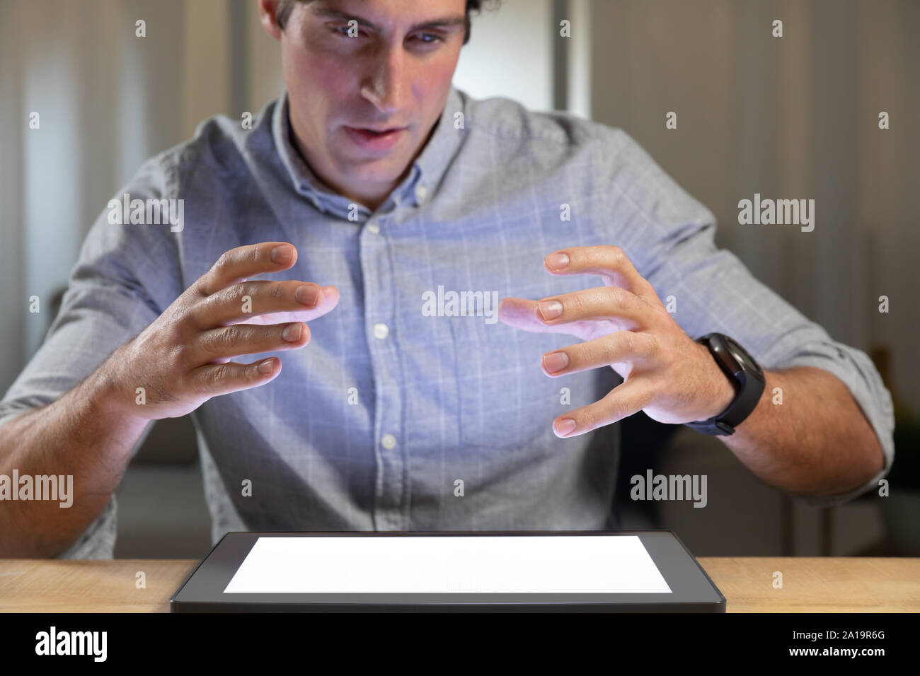 Young man using tablet computer on a table Stock Photo
