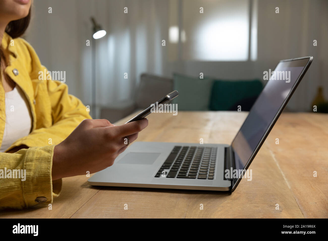 Young woman using laptop computer and smartphone Stock Photo