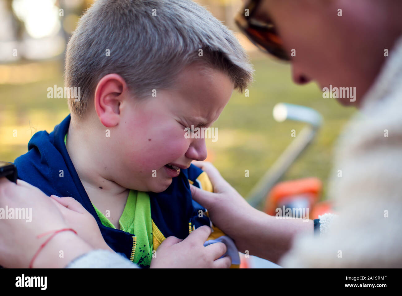 Boy crying and mom trying to calm him down. Children, parents and emotions concept Stock Photo