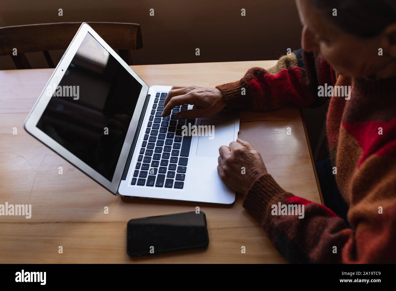 Senior woman using laptop at home Stock Photo