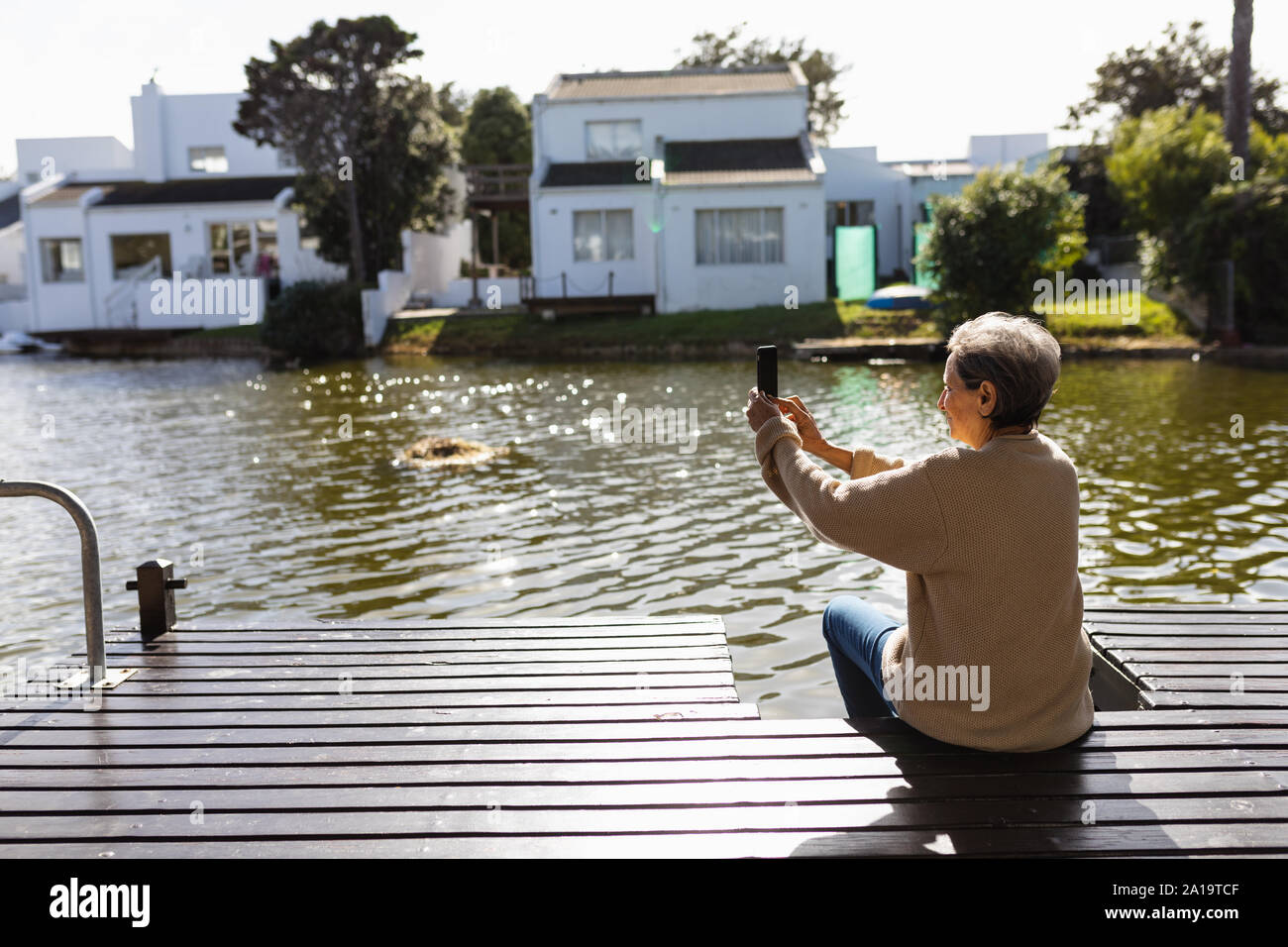 Senior woman using smartphone outdoors Stock Photo