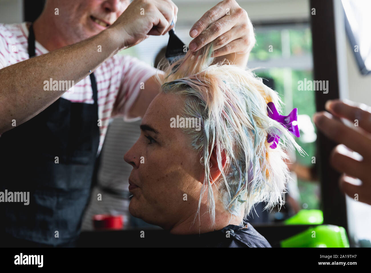 Male hairdresser and female client in hair salon Stock Photo - Alamy
