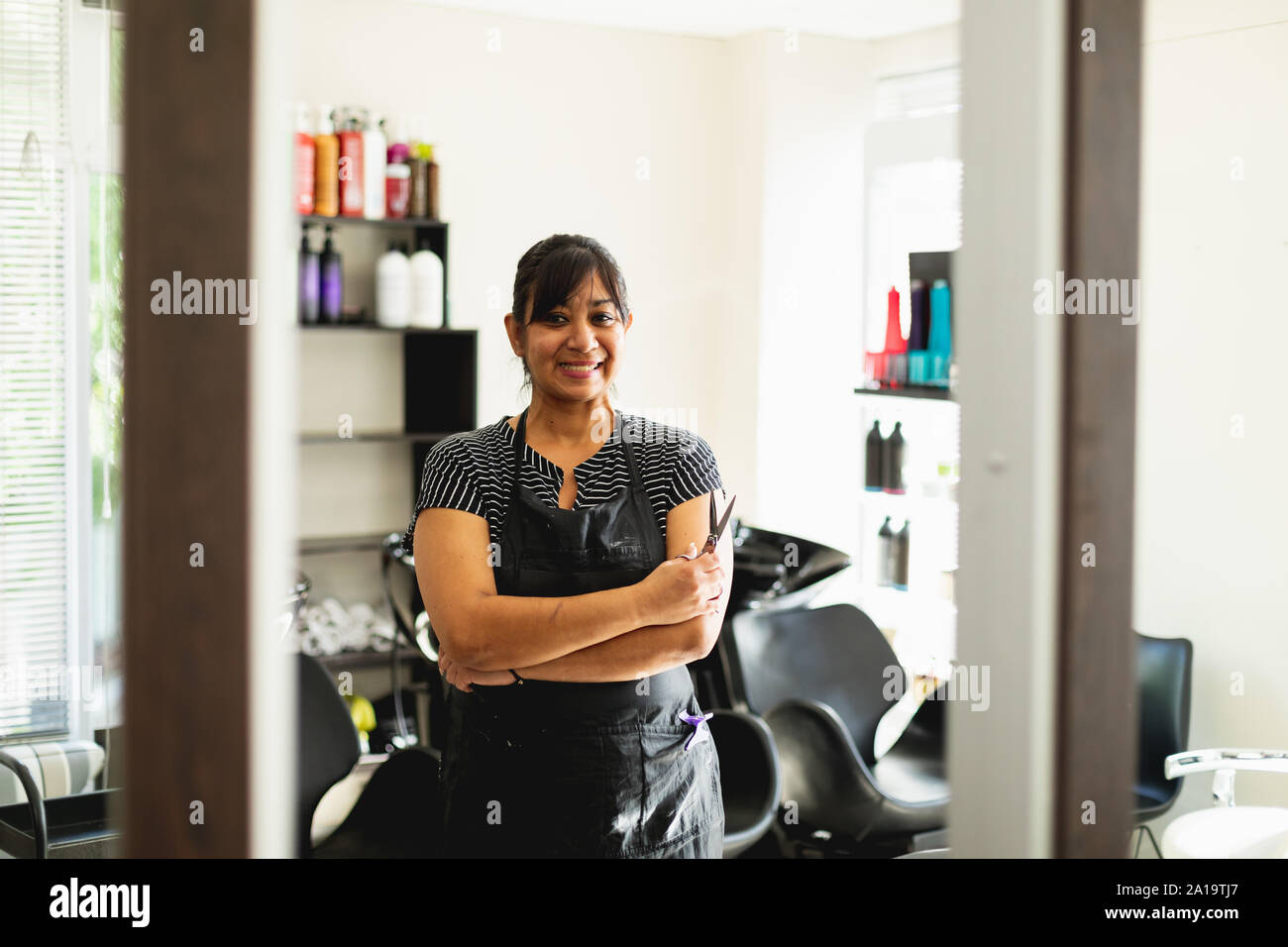 Female hairdresser in hair salon Stock Photo