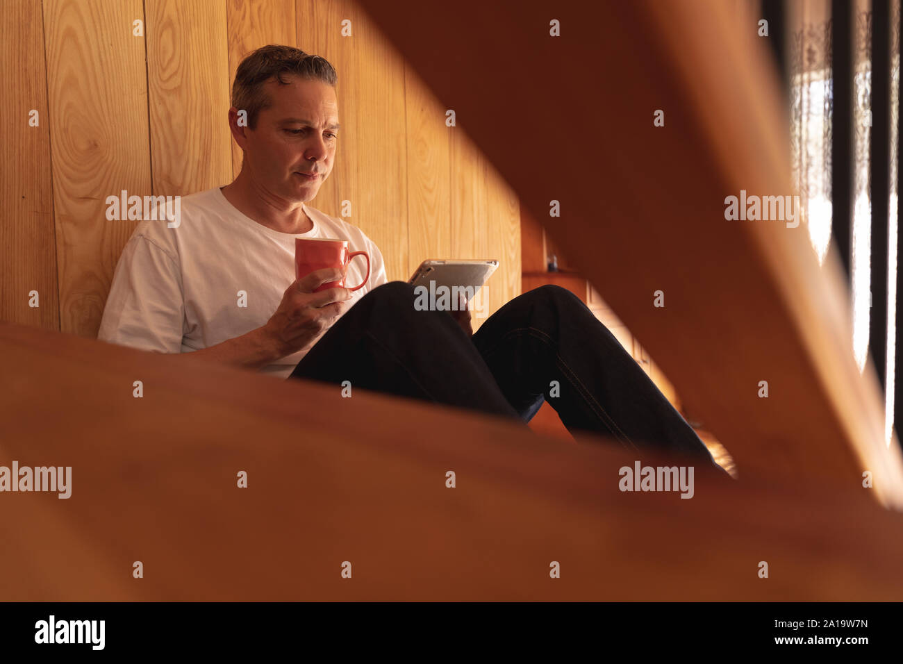 Man using tablet at home Stock Photo