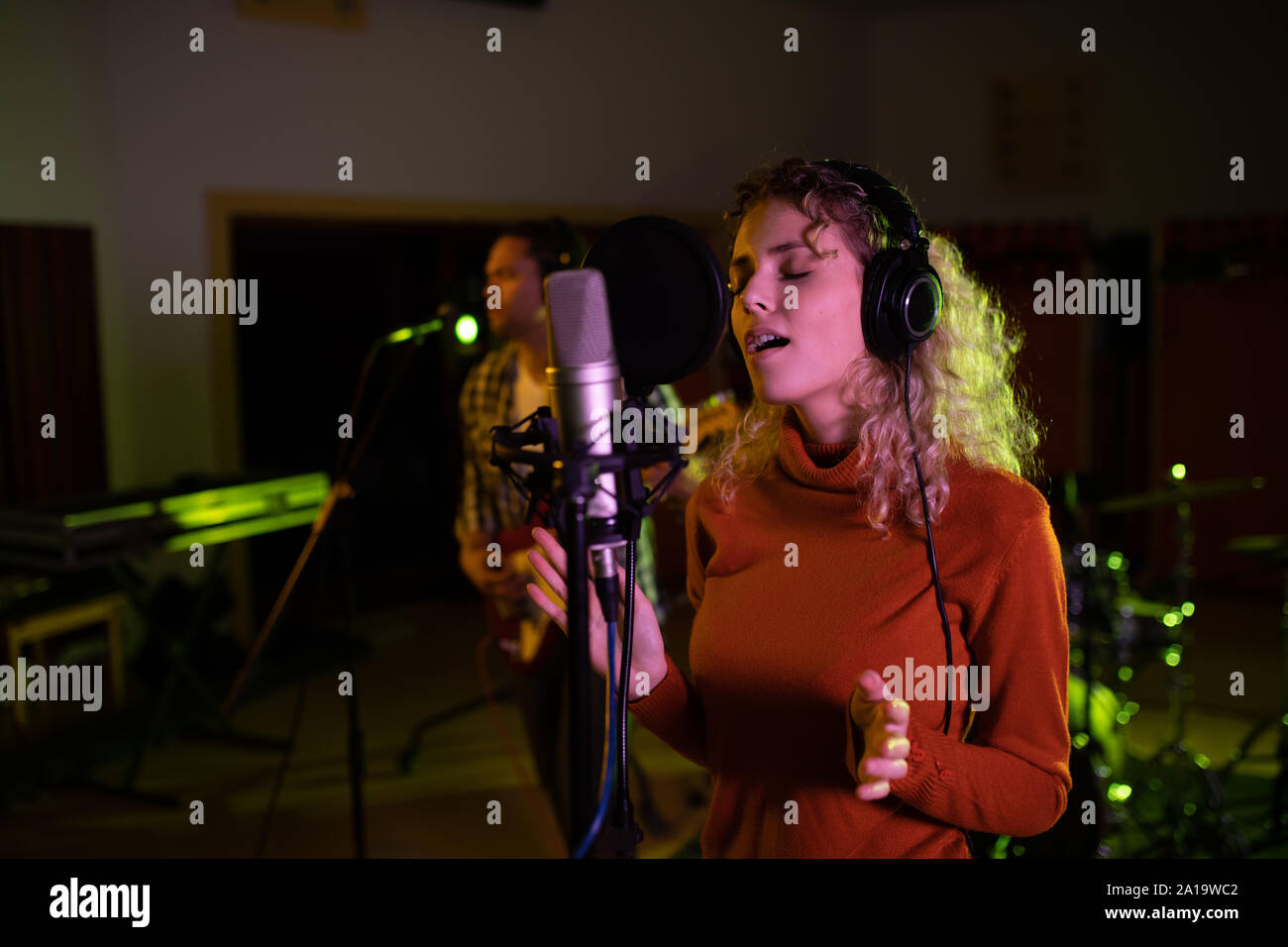 Female singer recording in a sound studio Stock Photo - Alamy