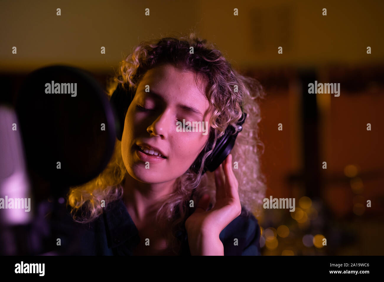 Female singer recording in a sound studio Stock Photo