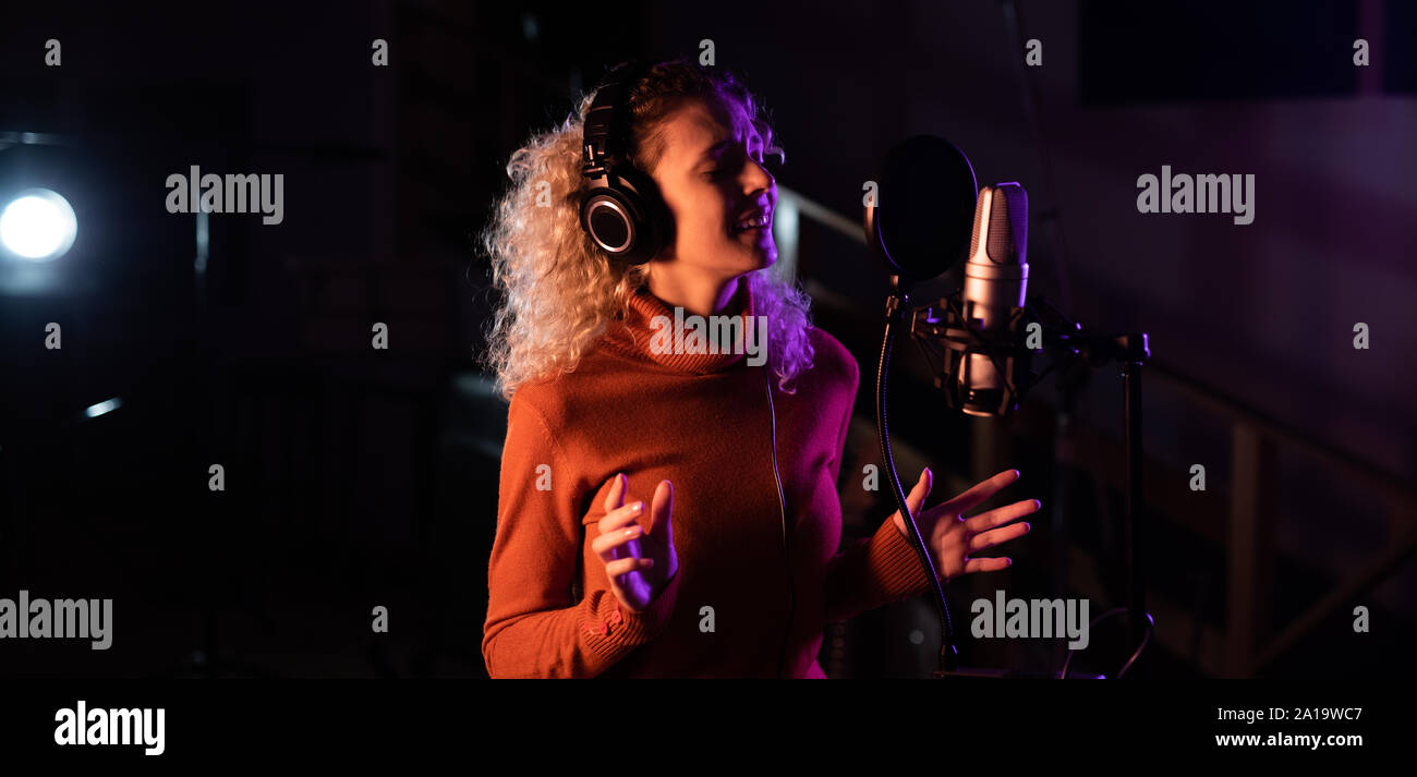 Female singer recording in a sound studio Stock Photo - Alamy