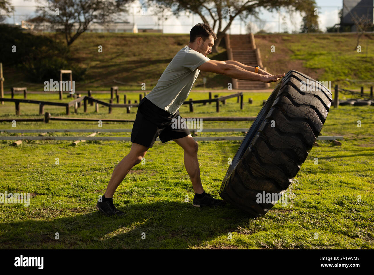 Young man training at an outdoor gym bootcamp Stock Photo - Alamy