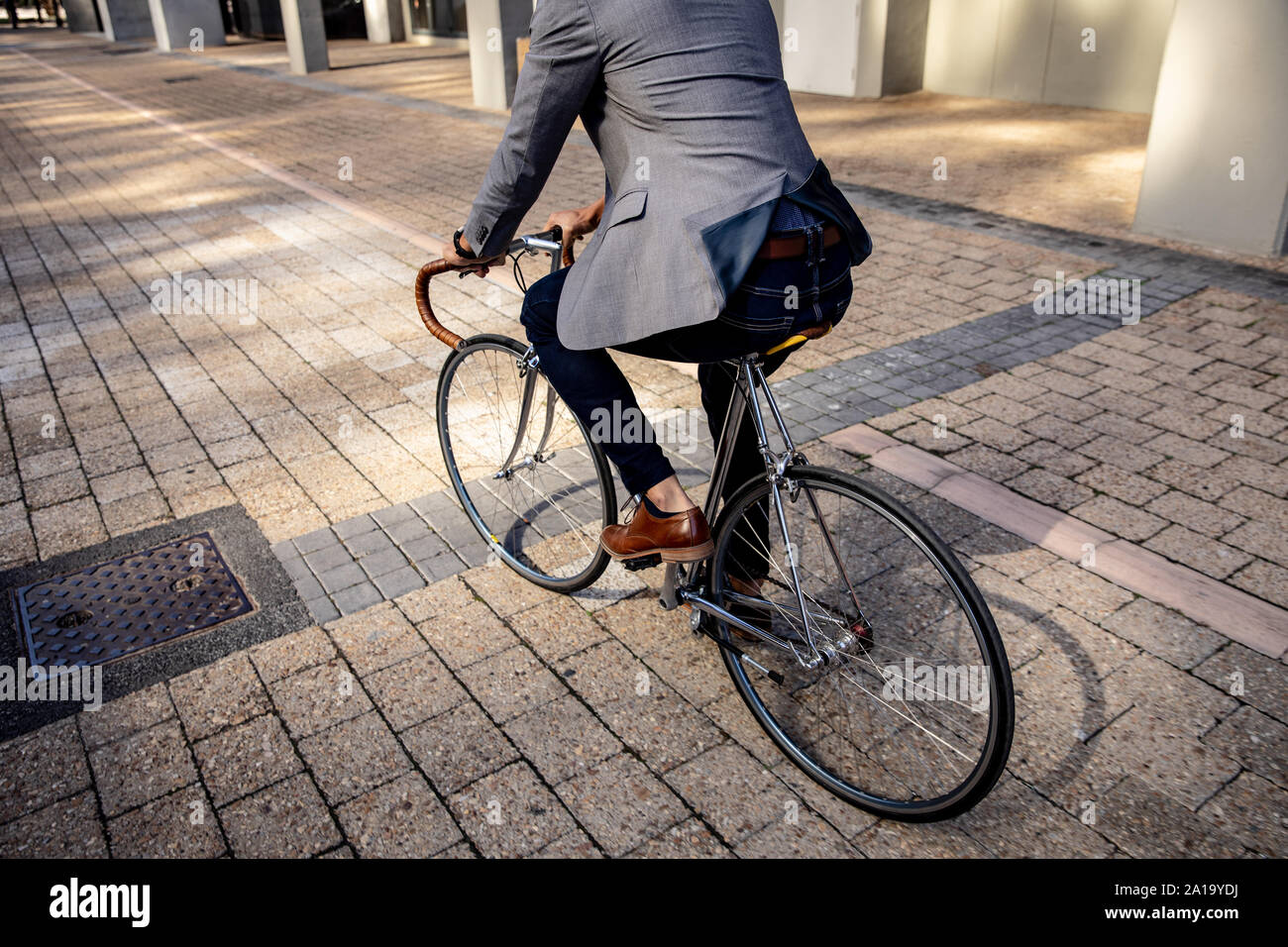 Young professional man riding a bike in a city Stock Photo