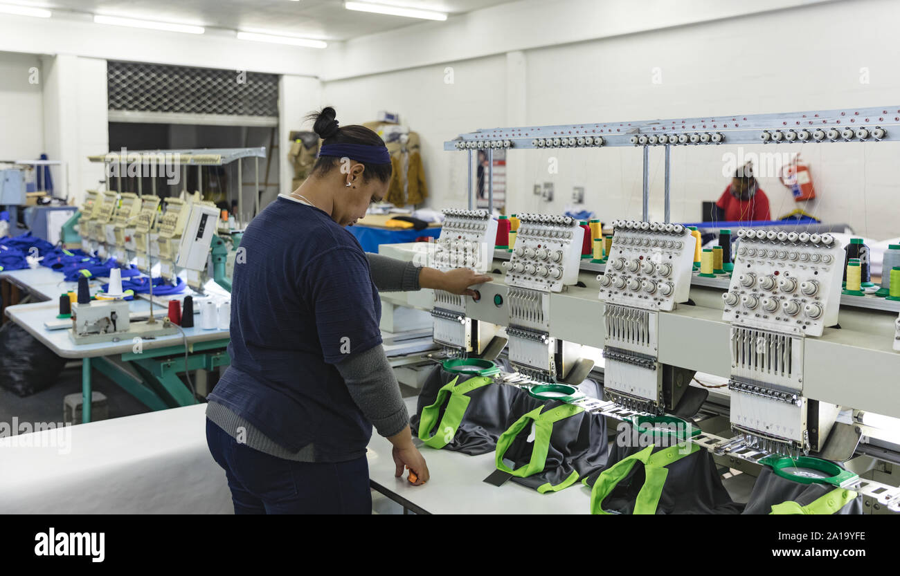 Women operating automated sewing machines Stock Photo