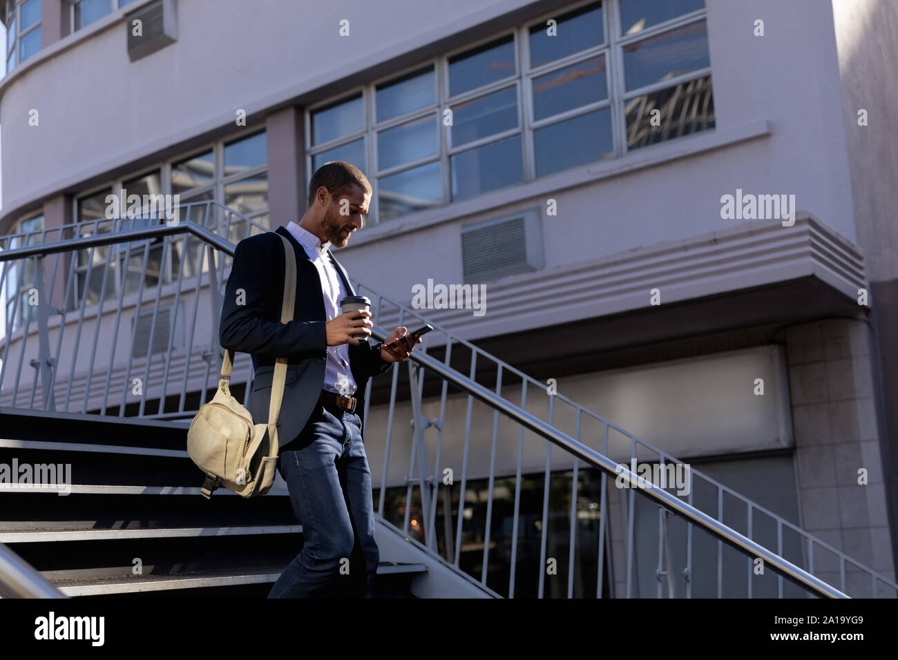 Young professional man using smartphone on the street Stock Photo