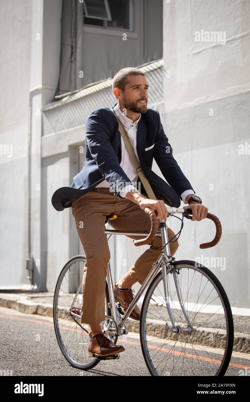Young professional man riding a bike in a city Stock Photo Alamy