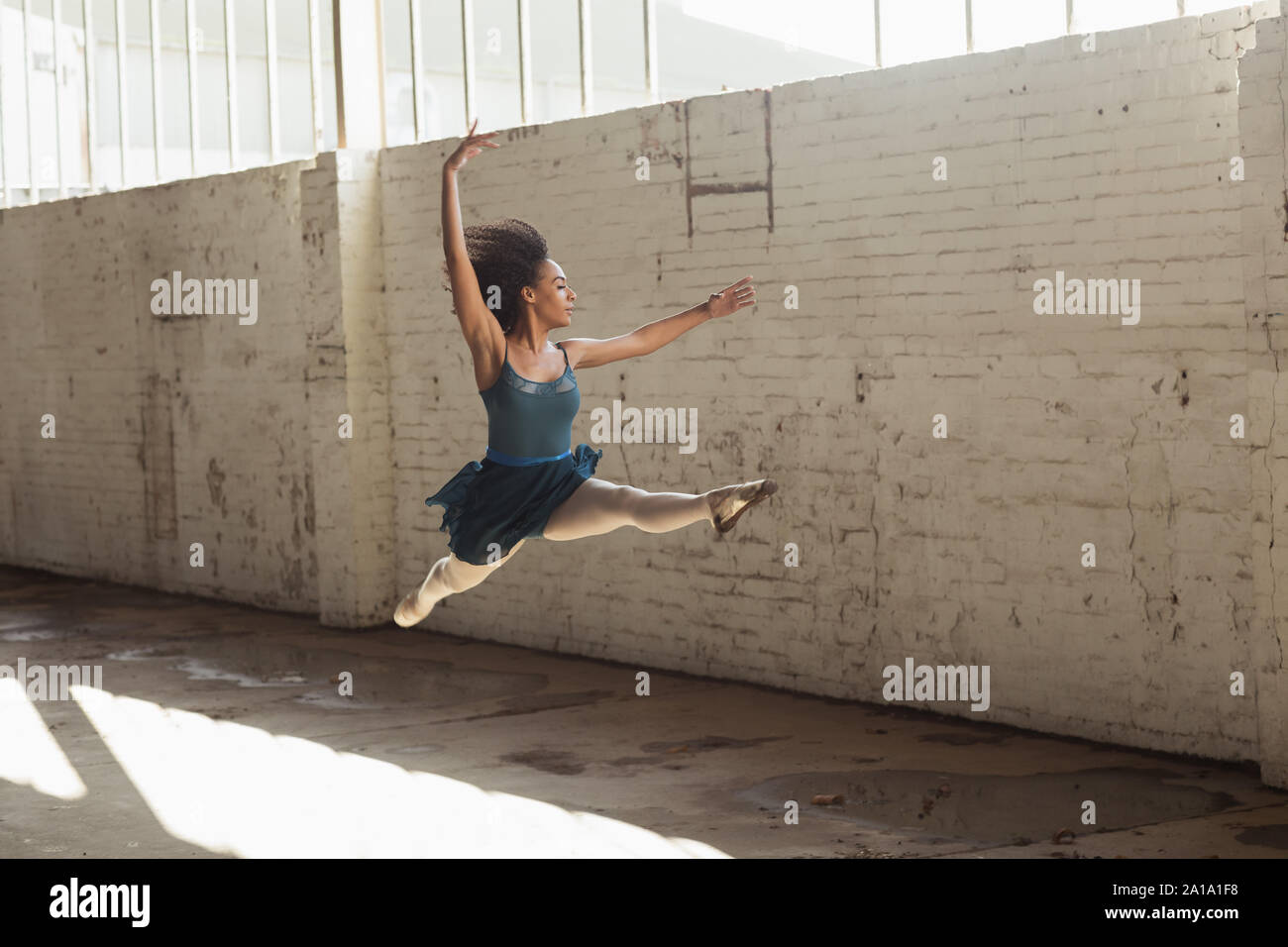 Female dancer in an empty warehouse Stock Photo