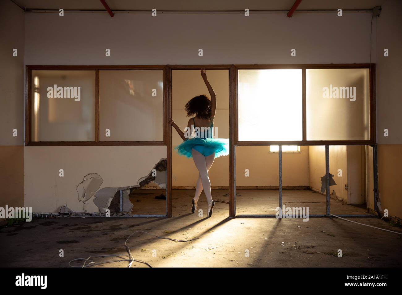 Female dancer in an empty warehouse Stock Photo