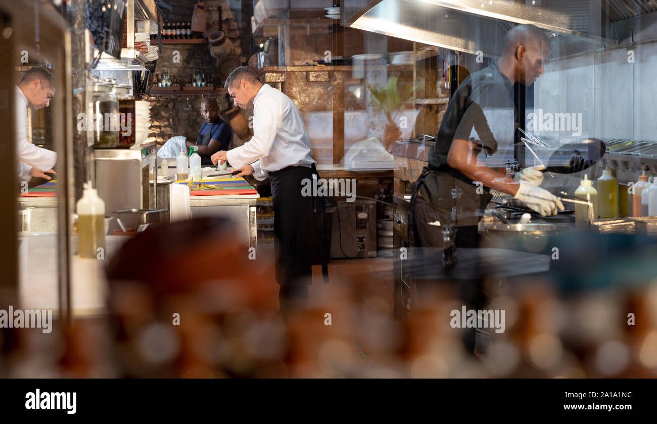 Men working in busy restaurant kitchen Stock Photo