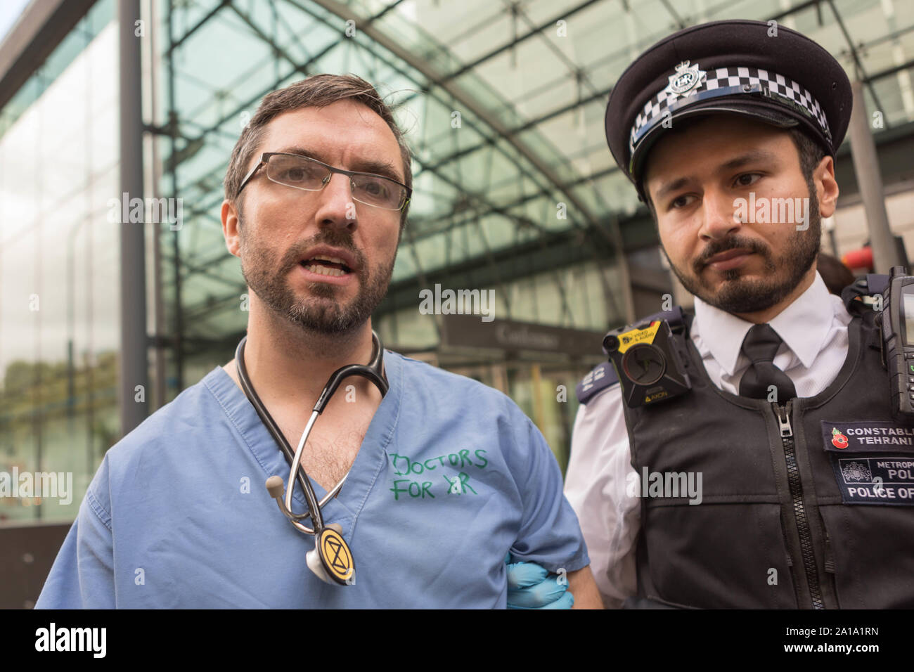 London, UK. 25th Sep, 2019. Doctors from the NHS representing environmental campaign group Extinction Rebellion, super glue themselves to the entrance outside the Department for Business, Energy and Industrial Strategy, Victoria Street, Westminster. Credit: Penelope Barritt/Alamy Live News Stock Photo