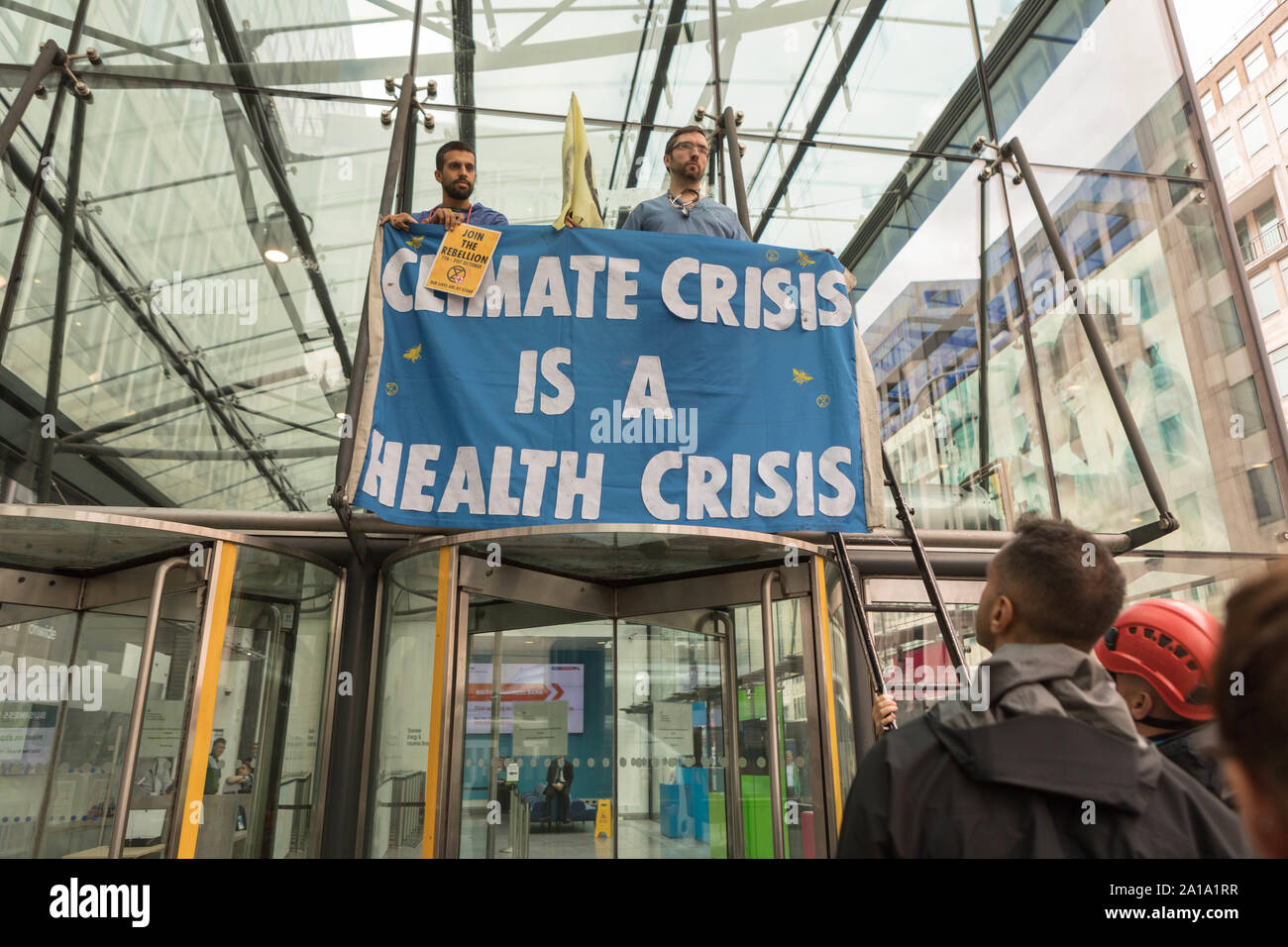 London, UK. 25th Sep, 2019. Doctors from the NHS representing environmental campaign group Extinction Rebellion, super glue themselves to the entrance outside the Department for Business, Energy and Industrial Strategy, Victoria Street, Westminster. Credit: Penelope Barritt/Alamy Live News Stock Photo