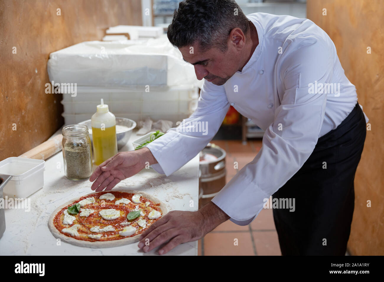 Head chef preparing pizza in a restaurant Stock Photo