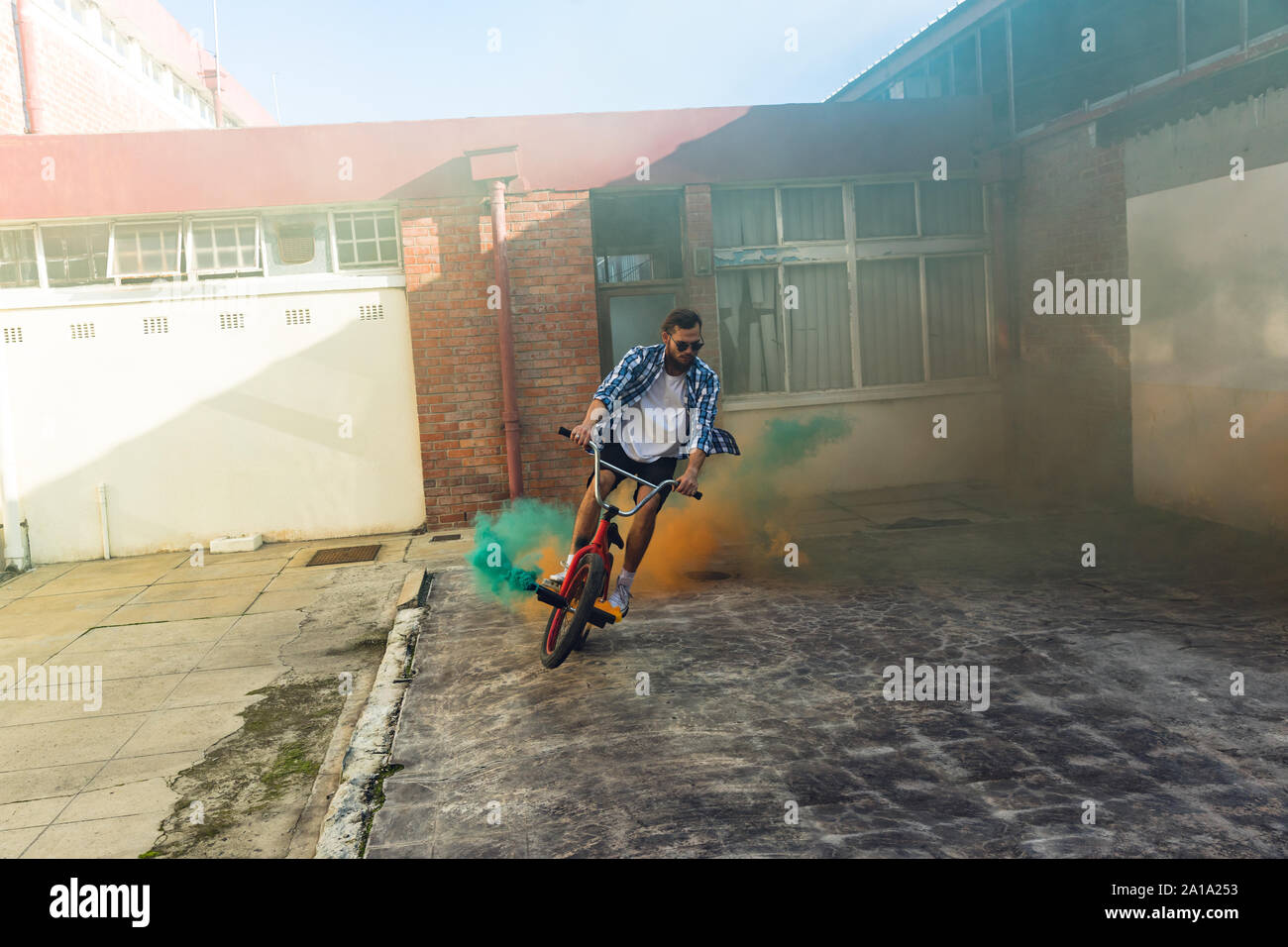 BMX rider using smoke grenades Stock Photo
