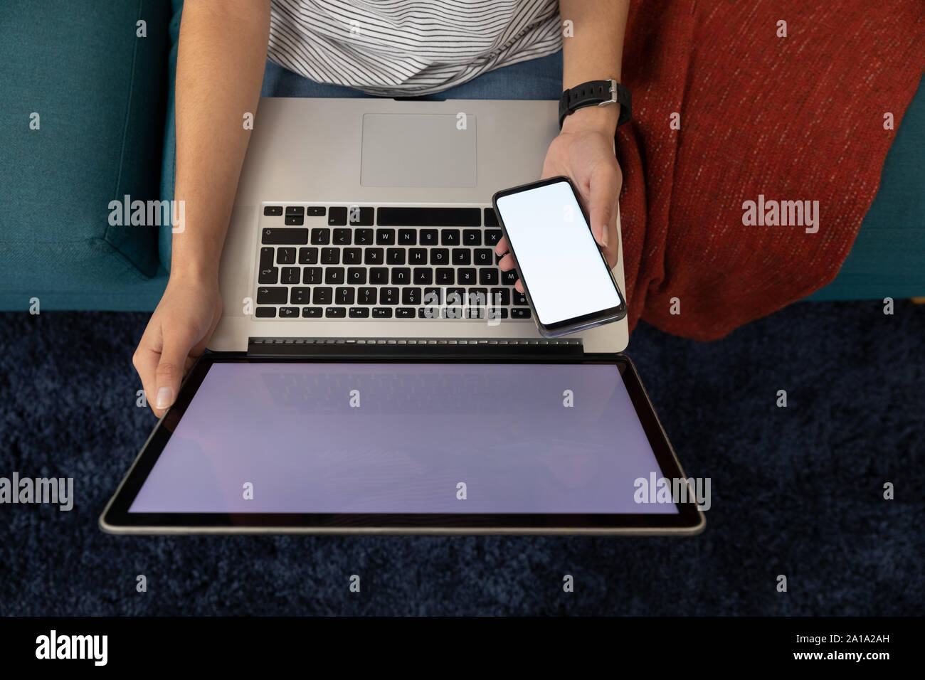 Woman using a smartphone and laptop Stock Photo