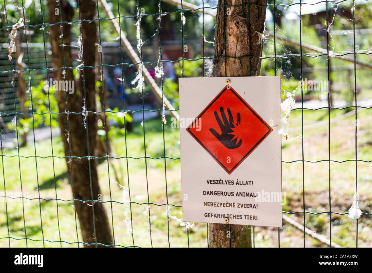 Dangerous animal sign on wire fence in zoo, Győr, Hungary Stock Photo