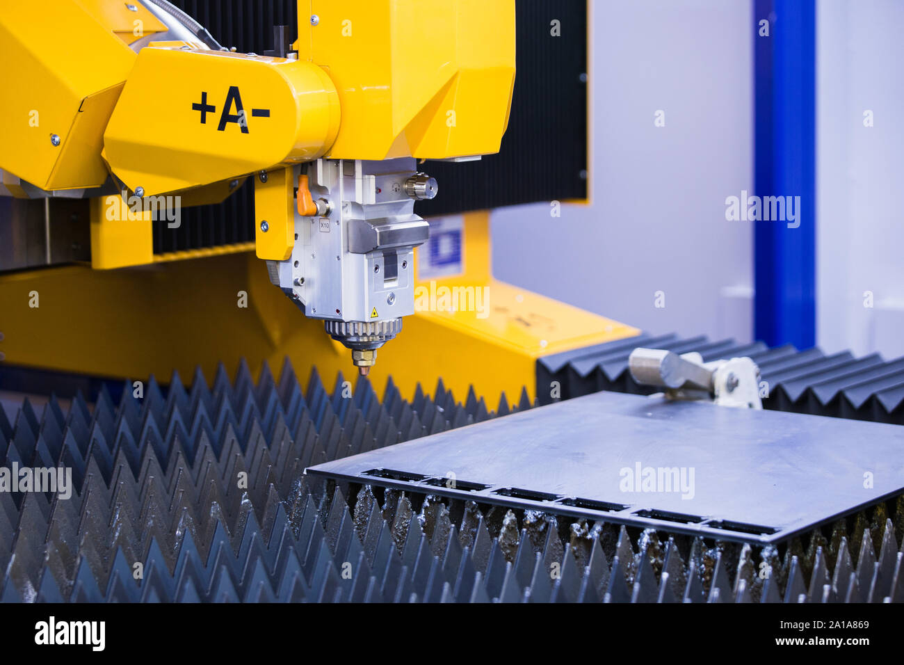 Automatic machine with robotic arm for cutting metal. Smart factory Stock Photo