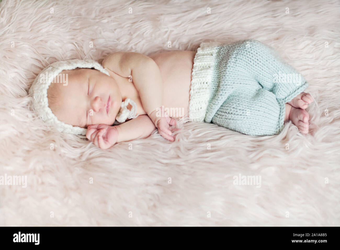 Sleeping Newborn baby on white fluffy blanket Stock Photo Alamy