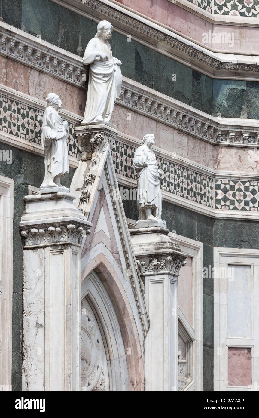 East entrance to Giotto's Campanile tower, Florence, Italy. 'Two Prophets and the Redeemer' on top of the gable above the entrance door, are both attr Stock Photo