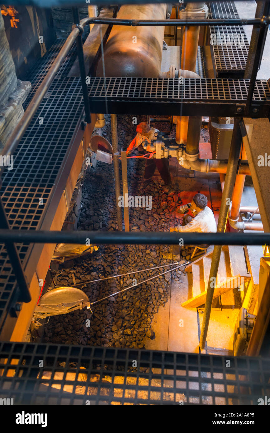 Re-created Engine room and furnace being fed coal by mannequin model figures; engine of the SS Great Britain, Brunel's steam powered ship in dry dock in in Bristol. UK England (109) Stock Photo