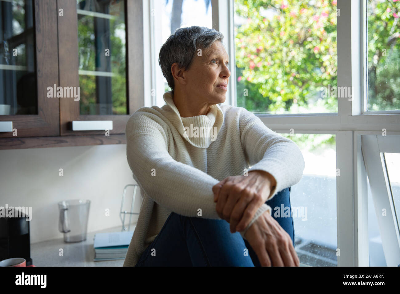 Mature woman alone at home Stock Photo