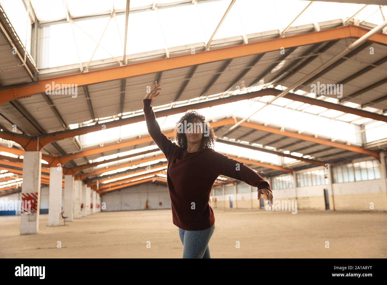 Female dancer in an empty warehouse Stock Photo